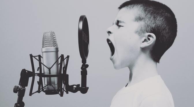 boy singing on microphone